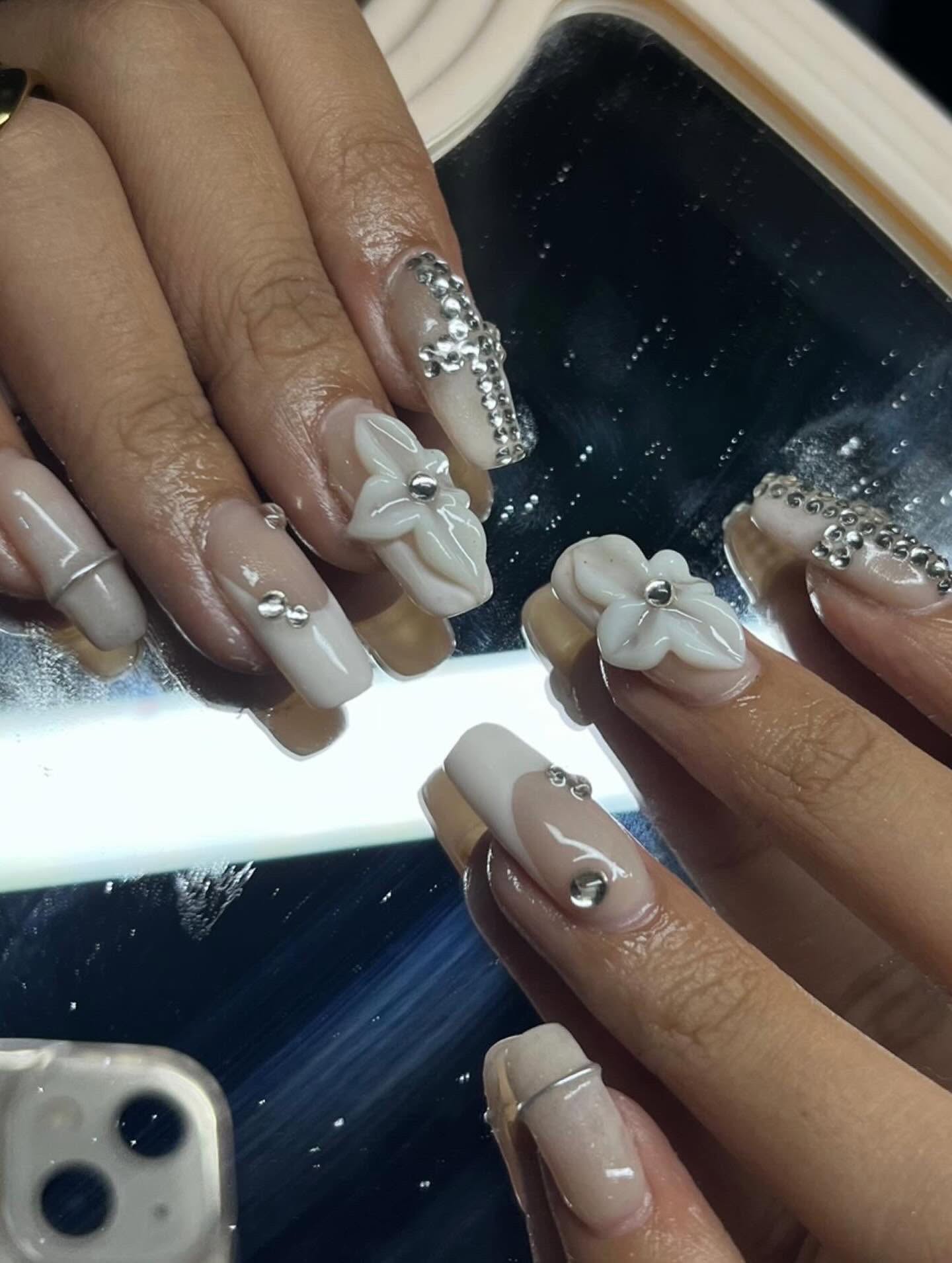 Floral nail art with hand-painted rose and leaf details